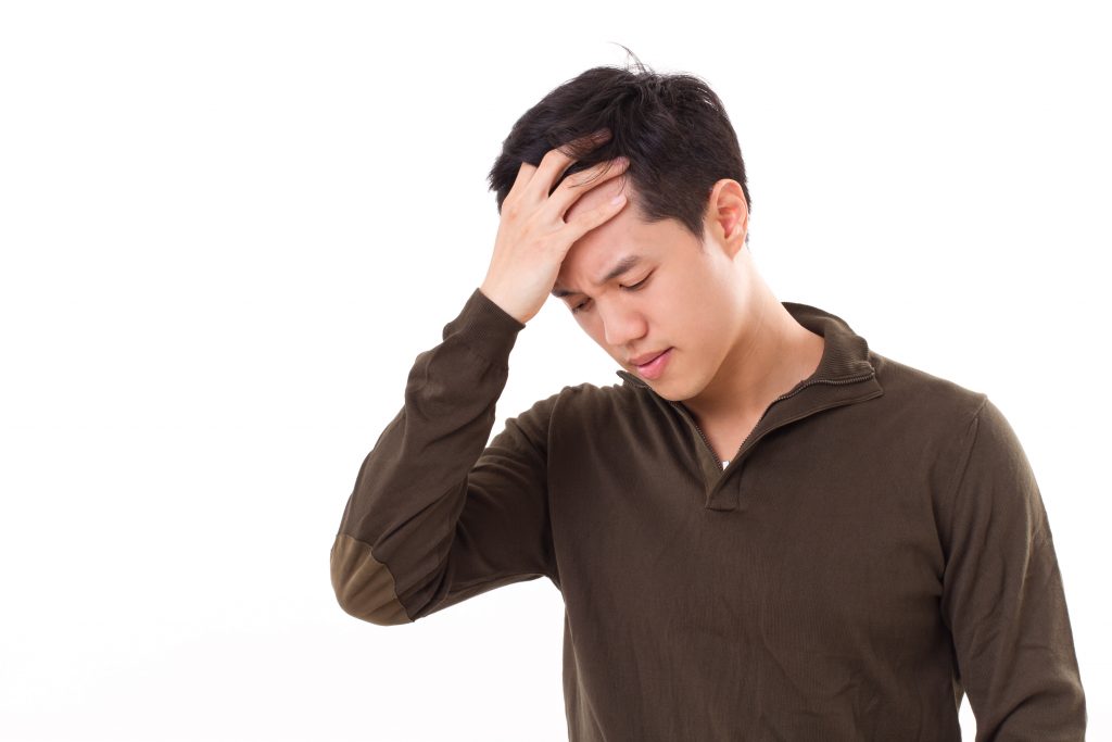 sick, stressed man suffers from headache pain